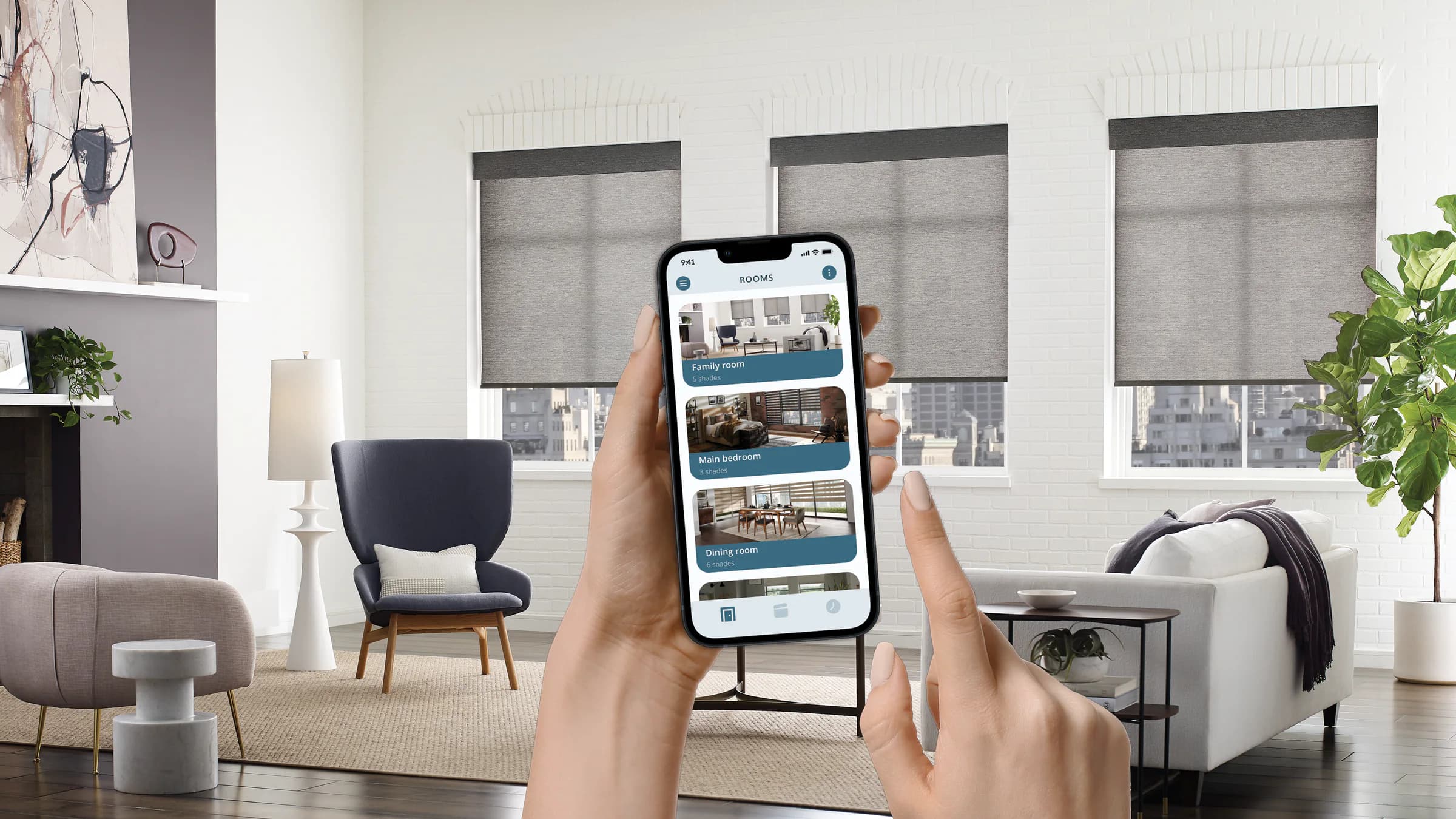 A homeowner using the BLISS app beside motorized roller shades