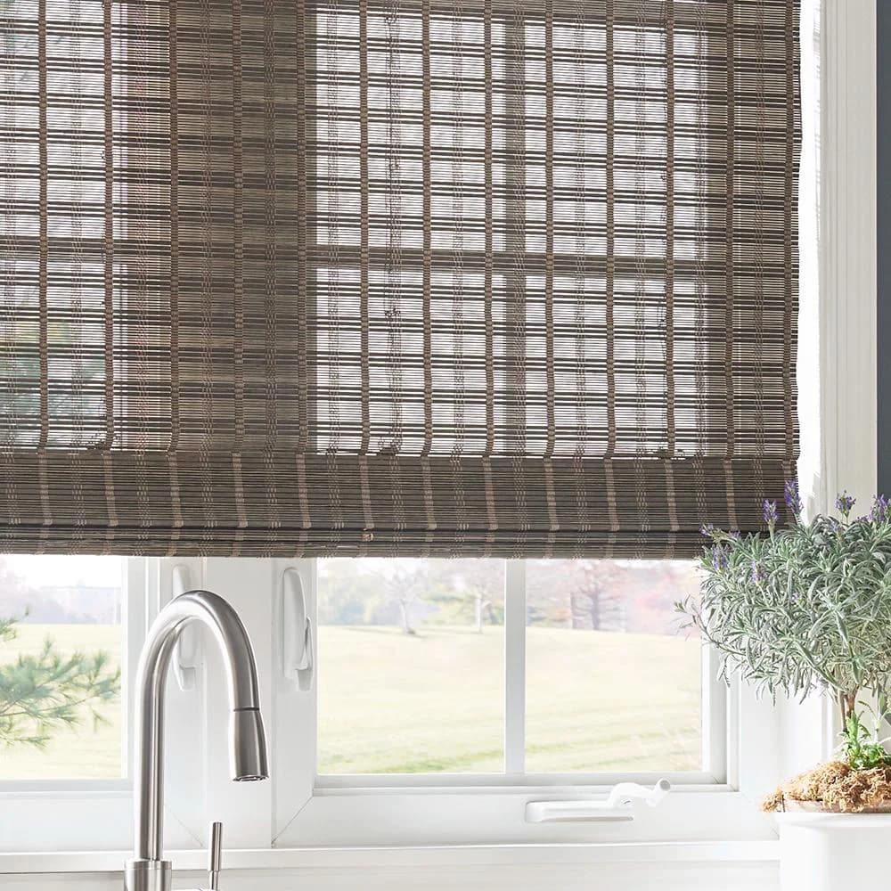A dark natural woven shade adding texture above a kitchen window