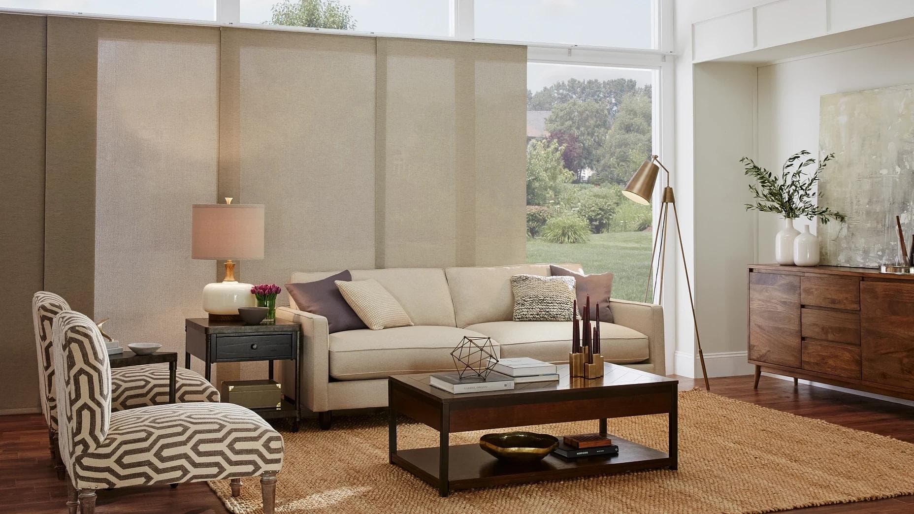 Coordinated roller shades across a bright living room