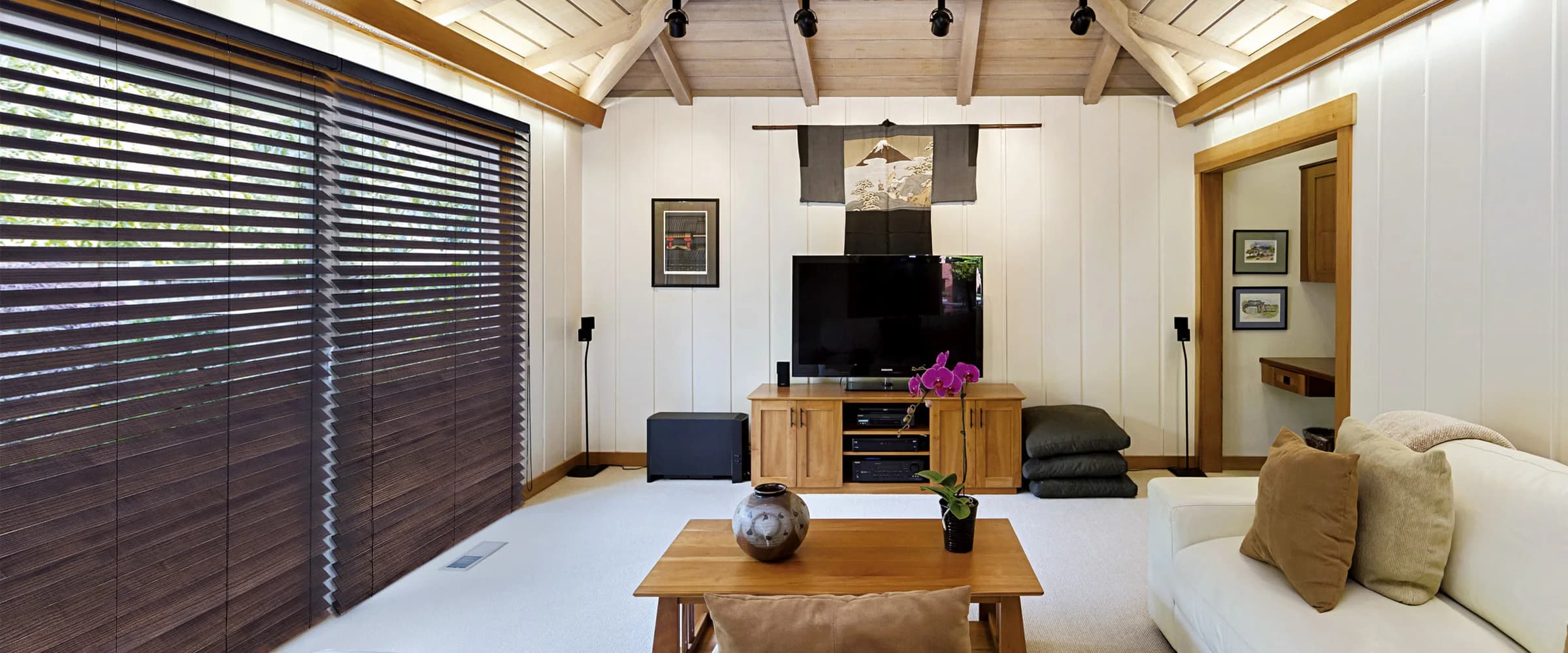 Dark wood blinds fitted across a wide living-room window wall