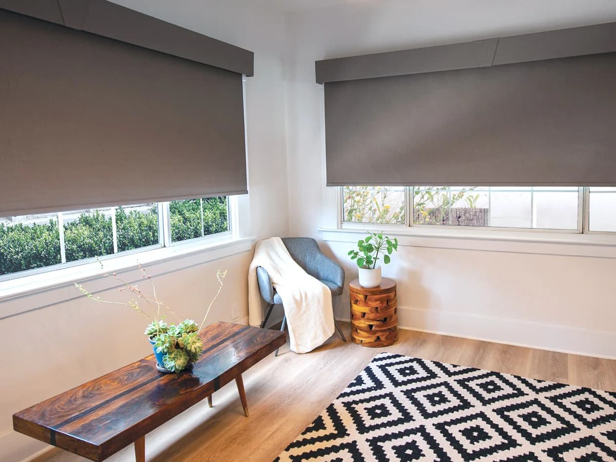 Solar shades filtering sun across a wide contemporary window