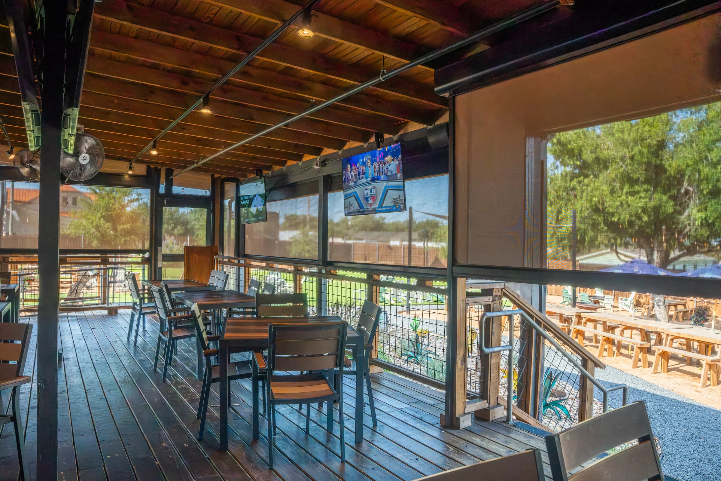 Exterior solar screens enclosing an open-air restaurant patio