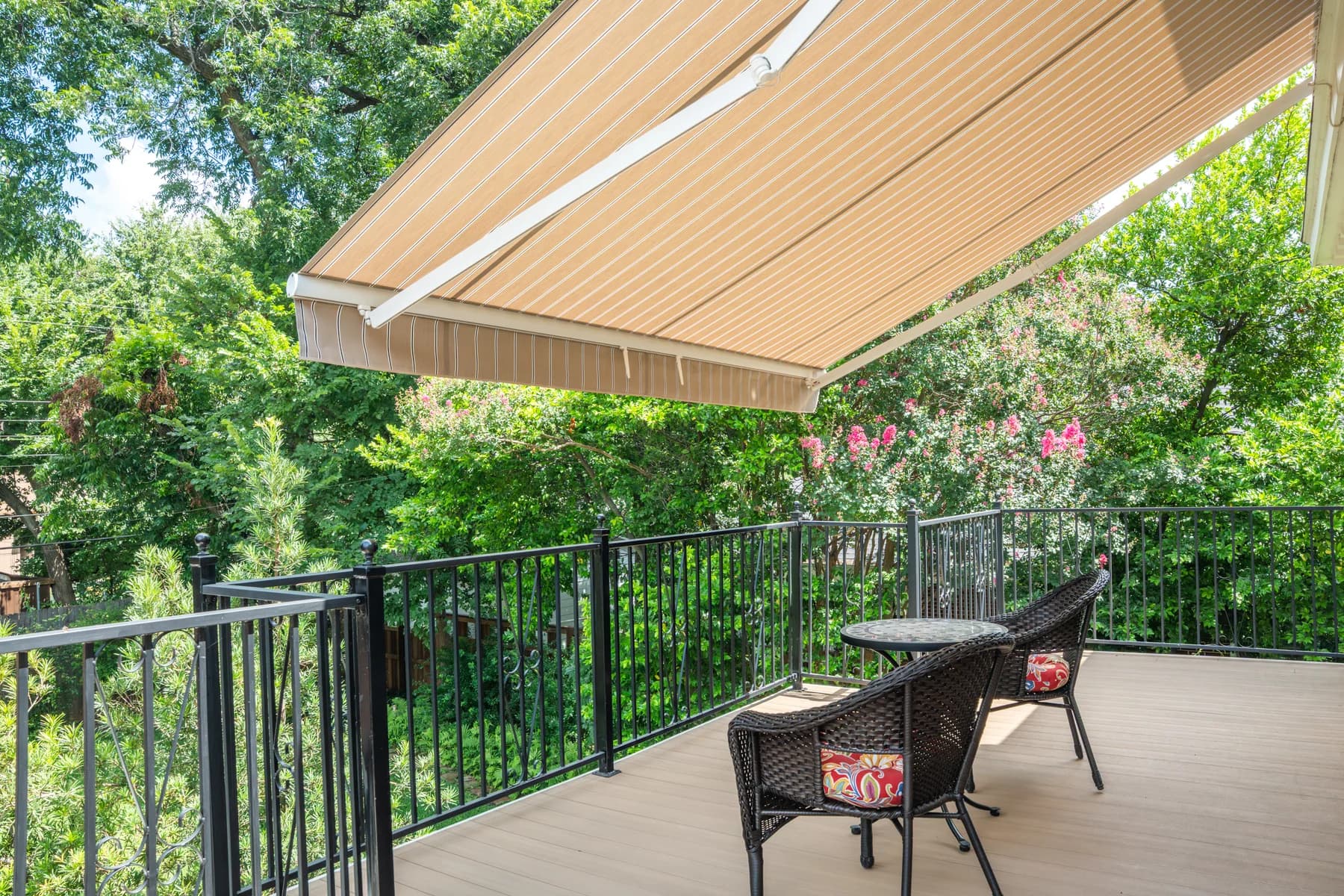 Retractable exterior awning shading a furnished residential deck