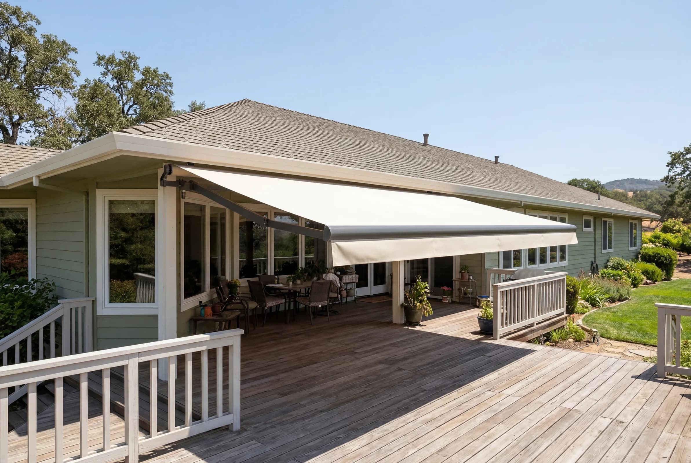 Open-roll exterior awning extended over a broad residential deck